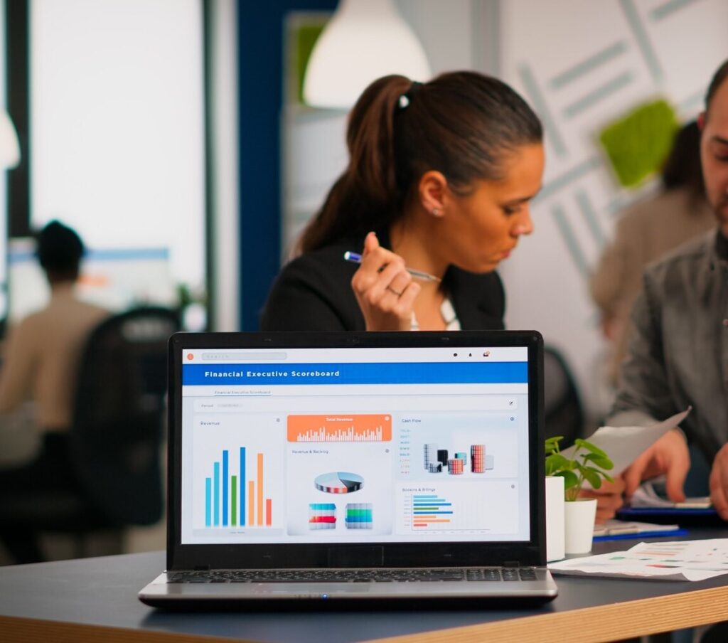Laptop showing analytics dashboard in office setting, discussing digital marketing services in Hyderabad.